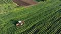 Tractor in agricultural field aerial view. Tractor working in agriculture field. Organic agriculture. Drone view.