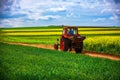 Tractor in a agricultural fields and dramatic clouds Royalty Free Stock Photo