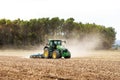 Panoramic view of a tractor plowing