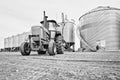 A tractor and a row of grain bins Royalty Free Stock Photo