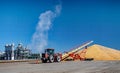 Tractor and Auger Unloading Corn at Ethanol Plant in the Midwest