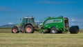 A tractor bailing grass for silage Royalty Free Stock Photo