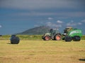 A tractor bailing grass for silage Royalty Free Stock Photo