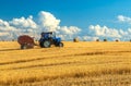 Tractor with bale machine for harvesting straw in the field and making large round bales. Agricultural work, harvesting Royalty Free Stock Photo