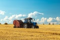 Tractor with bale machine for harvesting straw in the field and making large round bales. Agricultural work, harvesting Royalty Free Stock Photo