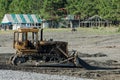 Tractor on beach evens out the surface. Preparing beach for summer season