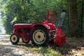 Tractor with cable winch during work in forest