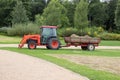 Tractor and cart with hay in garden Royalty Free Stock Photo