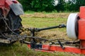 Tractor and cardan shaft for coupling equipment, tractor in the field during haymaking Royalty Free Stock Photo