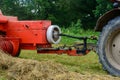 Tractor and cardan shaft for coupling equipment, tractor in the field during haymaking Royalty Free Stock Photo