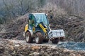 Tractor carrying cement slabs on a construction site