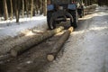 Tractor carrying logs. Forest harvesting. Sawn logs are tied to transport Royalty Free Stock Photo