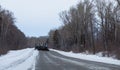 Tractor clean snow from the road. Russia. Chuiski