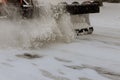 Tractor cleaning the road from the snow. Excavator cleans the streets of large amounts of snow in city.