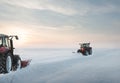 Tractor cleaning snow