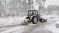 Tractor cleaning snow in the park