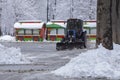 Tractor is sweeping snow in snowfall