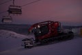 Tractor cleaning snow on the ski slopes in the Alps