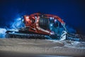 Tractor cleaning snow on the ski slopes in the Alps Royalty Free Stock Photo