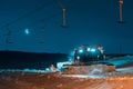 Tractor cleaning snow on the ski slopes in the Alps Royalty Free Stock Photo