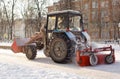 Tractor cleaning snow