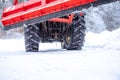 tractor cleans road from snow in the winter