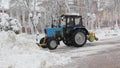 Tractor cleaning snow in the park