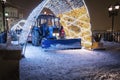 Tractor cleans snow on the Patriarshy Bridge near Cathedral of Christ the Saviour