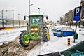 Tractor cleans the streets of large amounts of snow