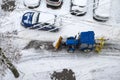 Tractor cleans the streets and parking from the fresh fallen snow. Heavy machinery outdoors cleaning road Royalty Free Stock Photo