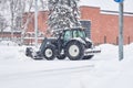 Tractor clearing street after a snow storm