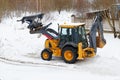 Tractor clears snow outside winter Royalty Free Stock Photo