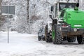 Tractor clears snow on road after heavy snowfall, road maintenance in winter season, harsh weather Royalty Free Stock Photo