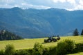 The tractor collecting the grass from the meadow Royalty Free Stock Photo