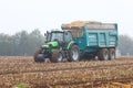 Tractor collecting the maize harvest in a large trailer