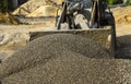 Tractor collects scoop with gravel. excavator extracts sand and gravel for concrete mix