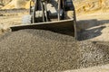 Tractor collects scoop with gravel. excavator extracts sand and gravel for concrete mix