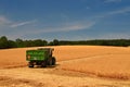 Tractor and combine harvester in the field during grain harvest. End of summer and harvest time. Concept for agriculture and Royalty Free Stock Photo