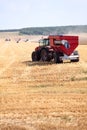 Tractor and combine harvesters working on a wheat field. Harvesting the wheat. Agriculture machinery Royalty Free Stock Photo