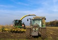 Tractor and corn harvester on the corn field