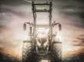 Tractor on country road with gloomy sky and clouds Royalty Free Stock Photo