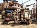 Tractor and crane near the residential houses in an unpaved street