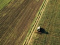 Tractor cultivating corn crop field, aerial view Royalty Free Stock Photo