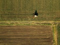 Tractor cultivating corn crop field, aerial view Royalty Free Stock Photo