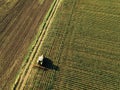 Tractor cultivating corn crop field, aerial view Royalty Free Stock Photo