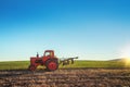 Tractor cultivating field at spring Royalty Free Stock Photo