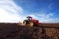 Tractor cultivating field at spring Royalty Free Stock Photo