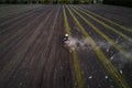 Tractor cultivating field at spring, aerial view