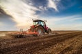 Tractor cultivating field at spring Royalty Free Stock Photo