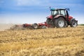 Tractor cultivating wheat stubble field, crop residue. Royalty Free Stock Photo